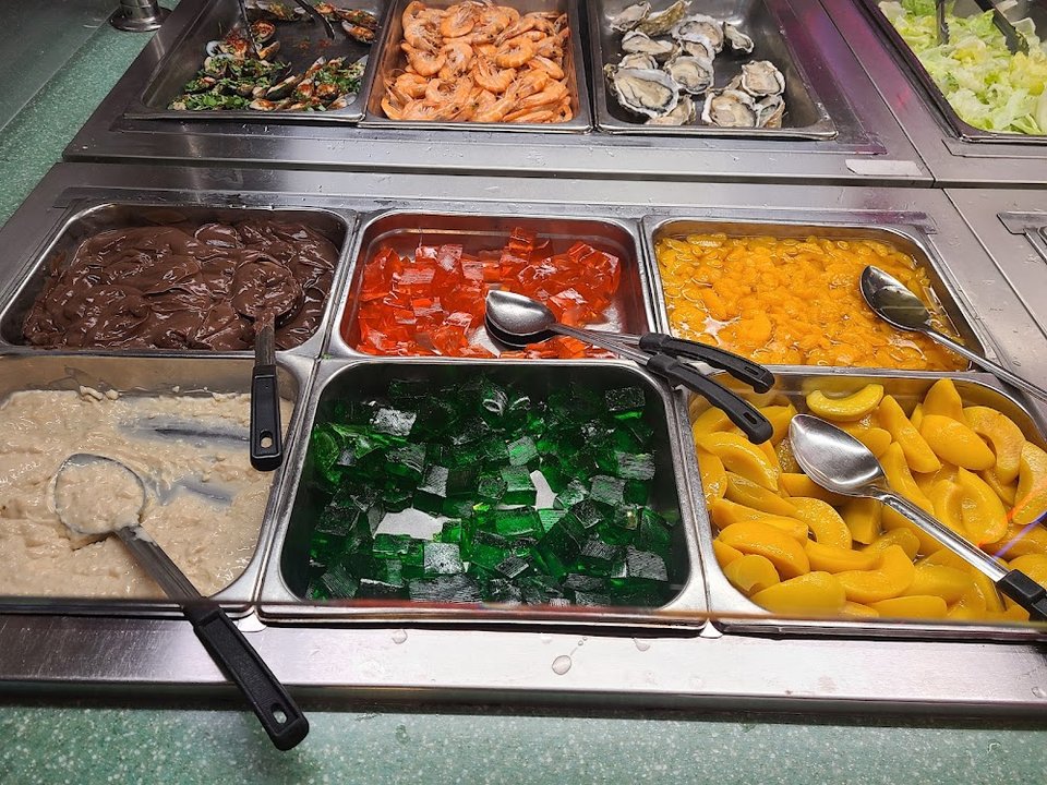 Breakfast buffet plates with coffee nearby.